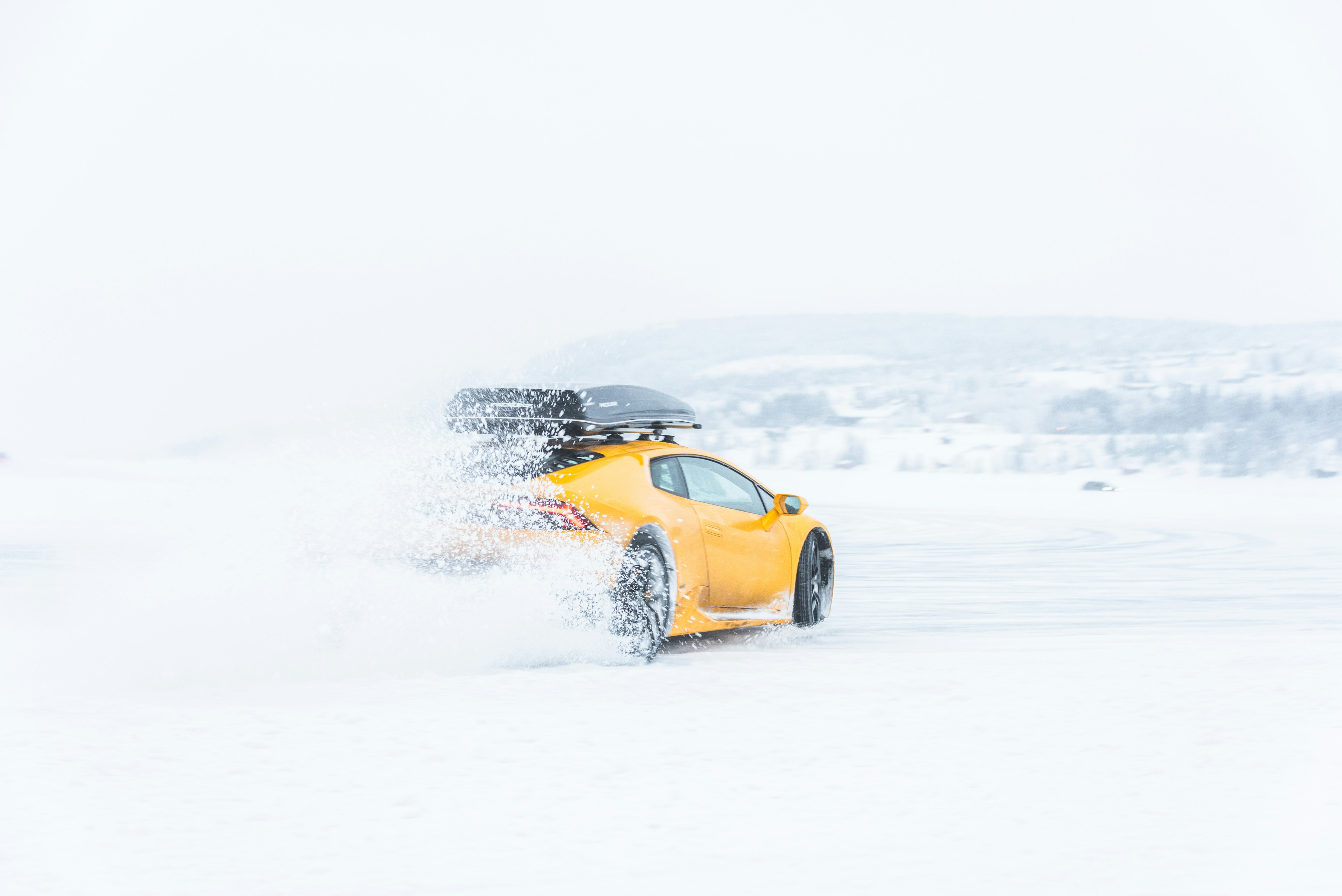 yellow coupe on snow field